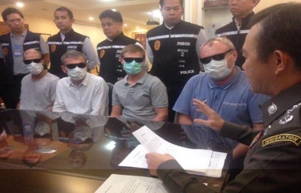 Vier Mitglieder der 10-köpfigen russischen Mafiabande verdecken mit Masken und Sonnenbrillen ihre Gesichter. 