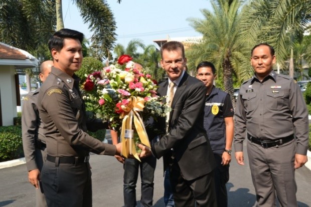 Polizeioberst Katatorn Khamtieng überreicht Rudolf Hofer ein Blumengebinde. 