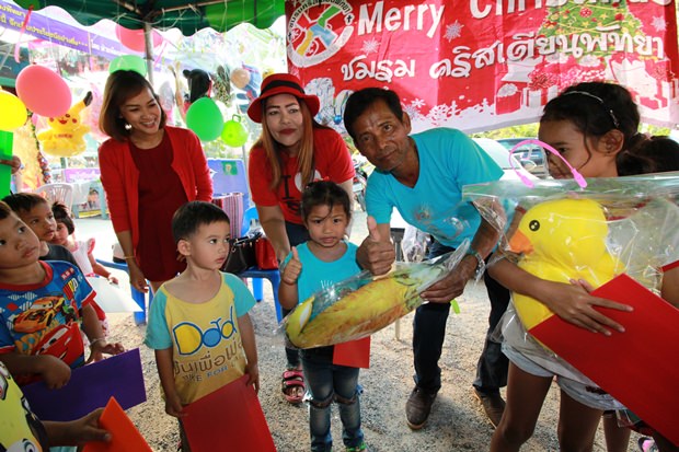 Wirat Joyjinda, der Vorsitzende der Soi Korpai Community verteilt Weihnachtsgeschenke an die Kinder. 